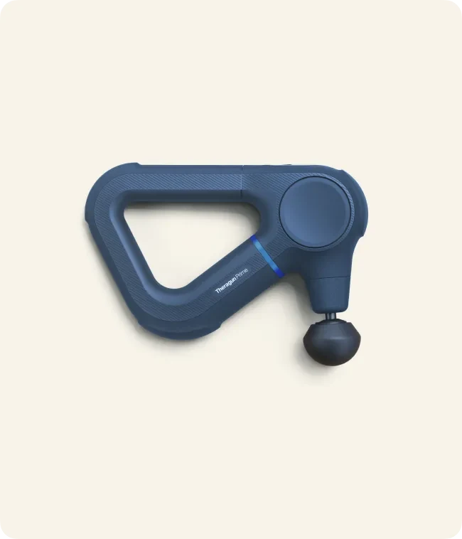 Navy Therabody Theragun Prime massage device on a cream background.